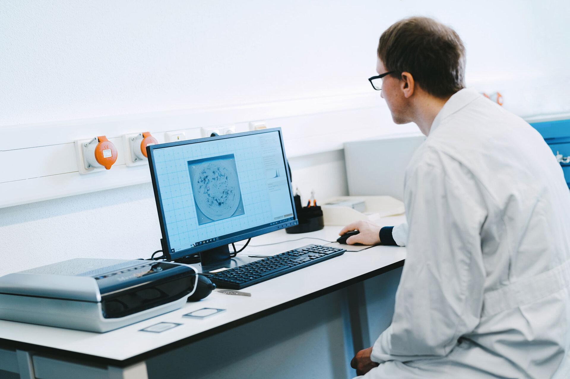 L'employé effectue une analyse de la propreté technique afin d'identifier les causes de défaillance dues aux particules dans les composants électroniques. | © @The Sour Cherry Fotografie - Michaela Curtis