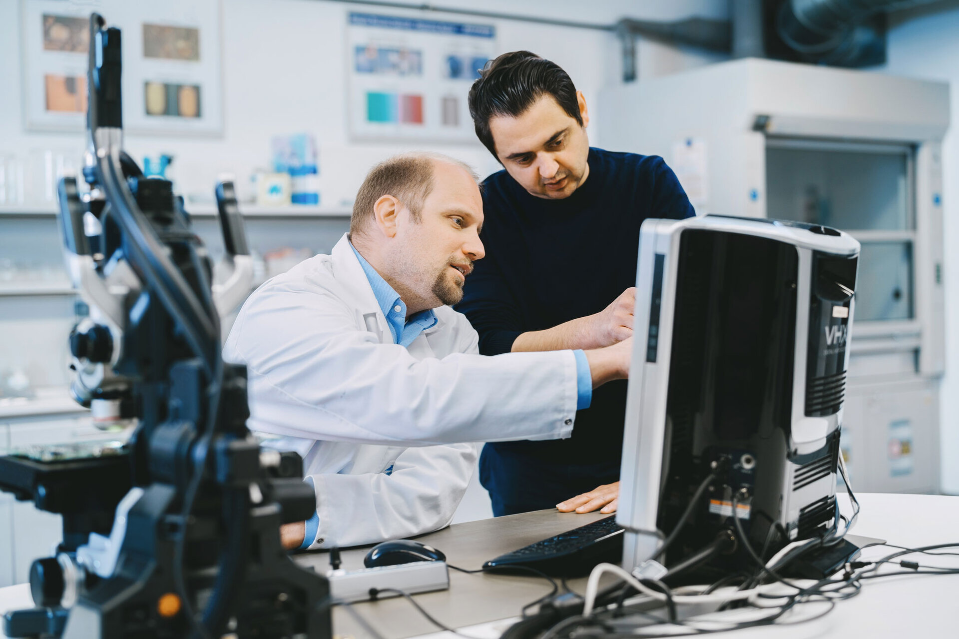 Two laboratory employees inspect a printed circuit board for surface cleanliness of electronic assemblies. | © @The Sour Cherry Fotografie - Michaela Curtis
