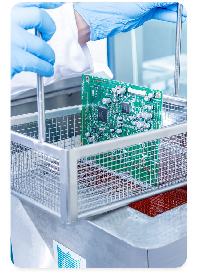 circuit board dipping into chemistry inside ultrasonic dip tank machine 