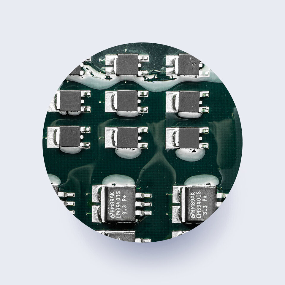 closeup of circuit board components covered in conformal coating 